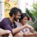 Two people smiling while using a phone