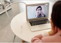 A doctor speaking to a patient online